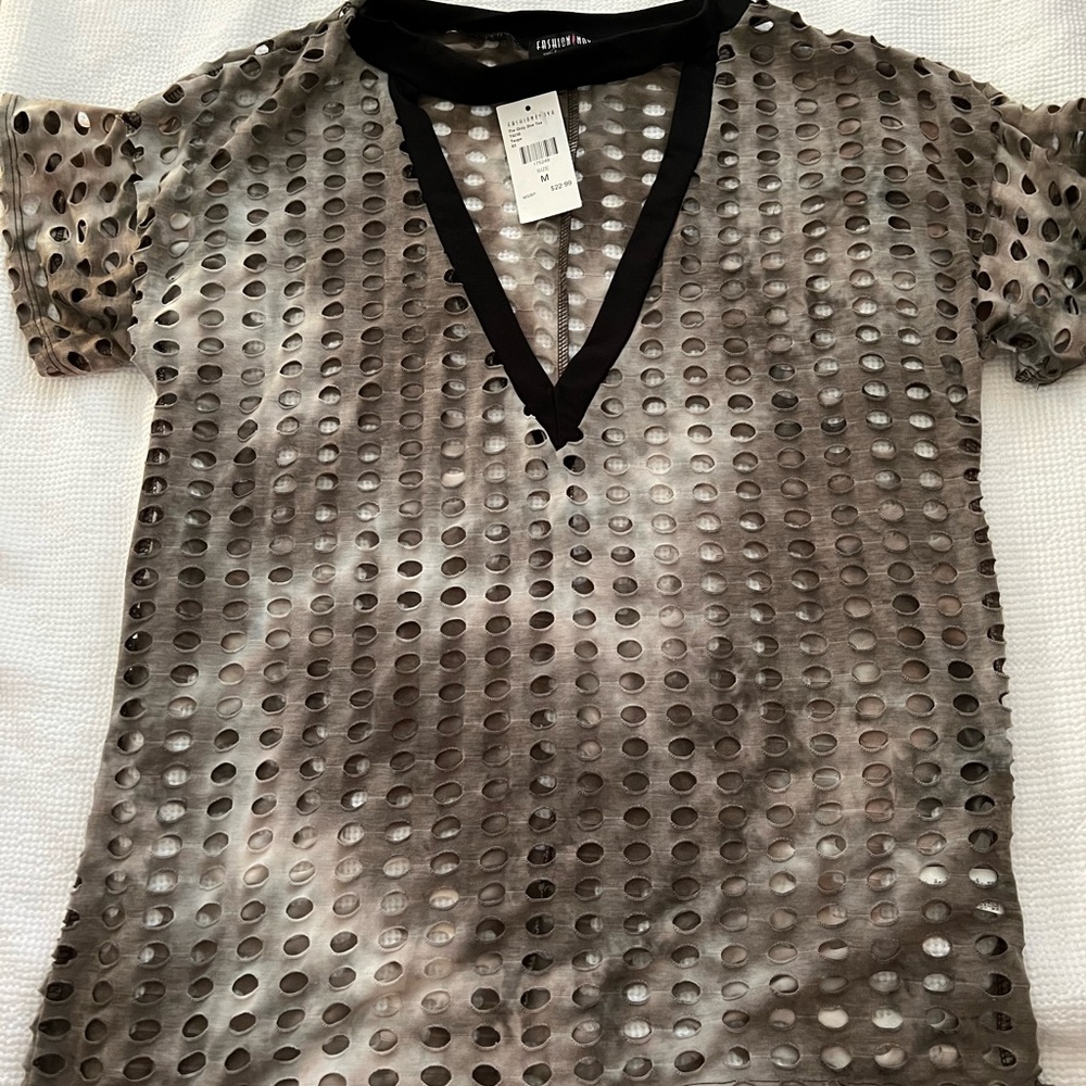 Shirt wit holes all over and a v lower front part